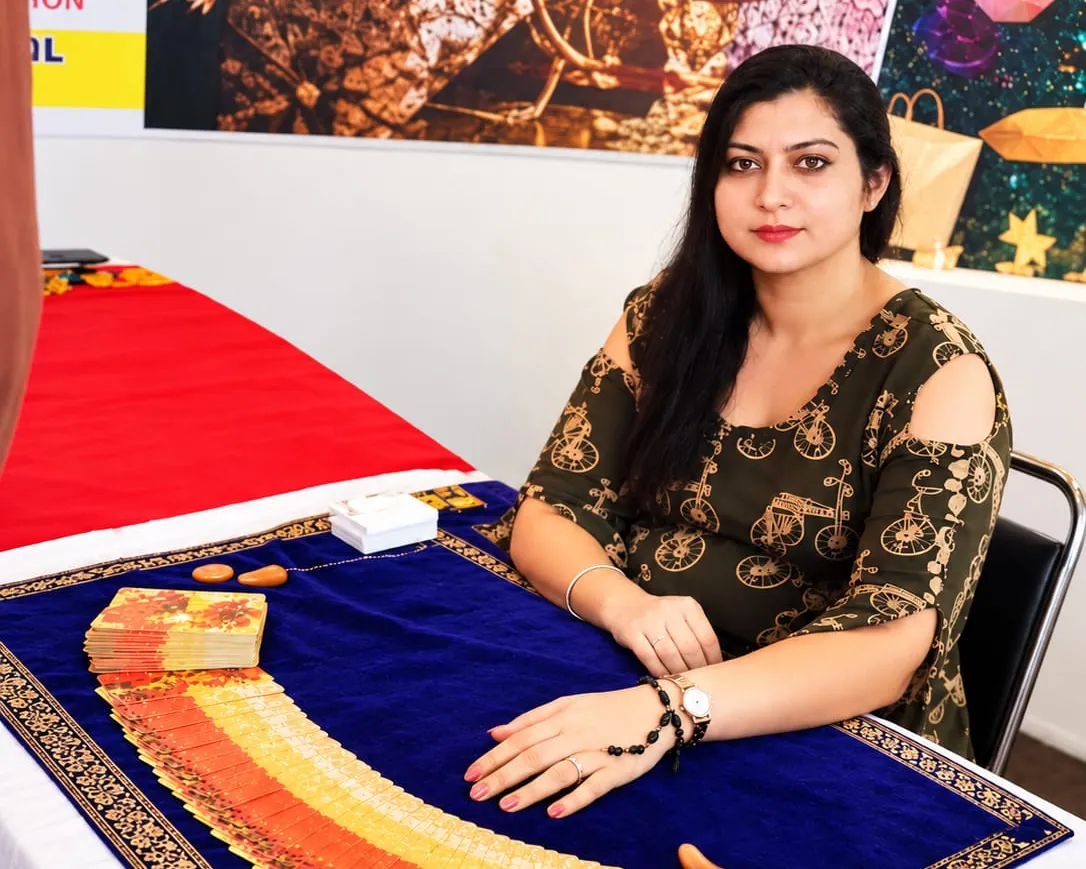 Binaca Patel at her reading table with a tarot deck spread out